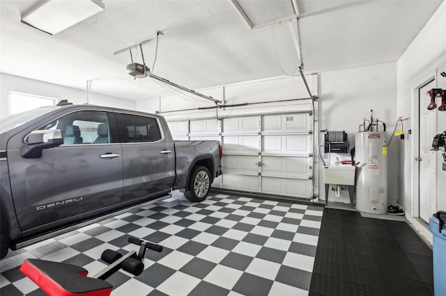 garage with a garage door opener, sink, and water heater