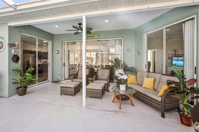 view of patio with an outdoor living space and ceiling fan