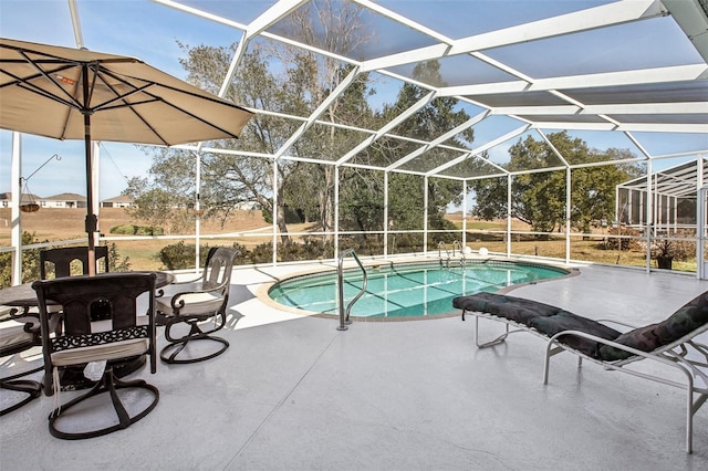 view of pool featuring glass enclosure and a patio area