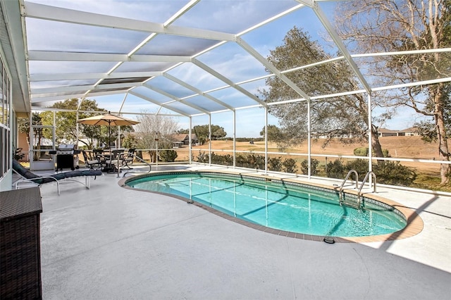 view of swimming pool with grilling area, glass enclosure, and a patio area