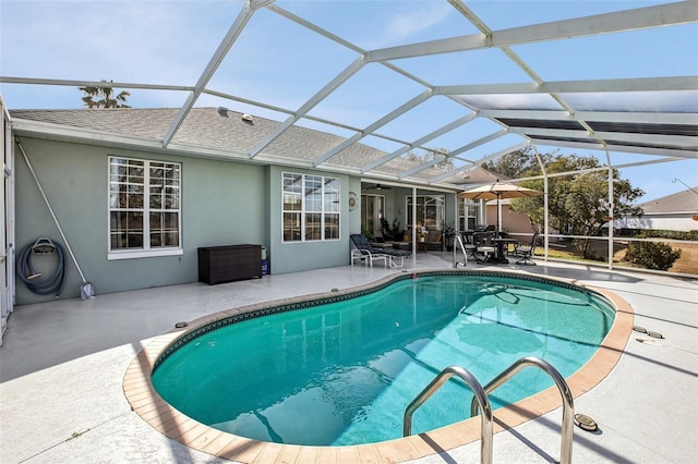 view of pool featuring a patio area and glass enclosure