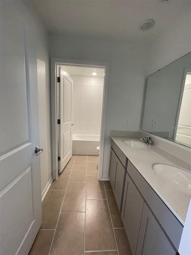 bathroom featuring vanity, tile patterned floors, and toilet