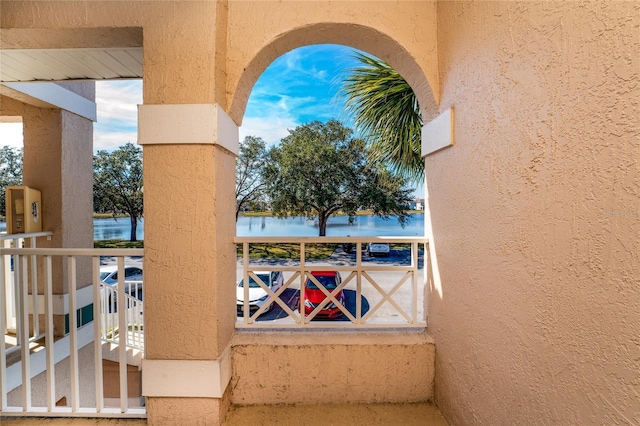 exterior space with a balcony and a water view