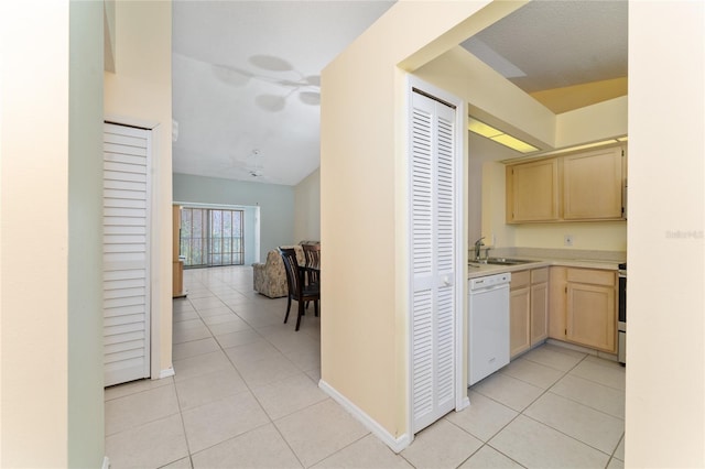 kitchen with sink, dishwasher, range, light tile patterned flooring, and light brown cabinetry