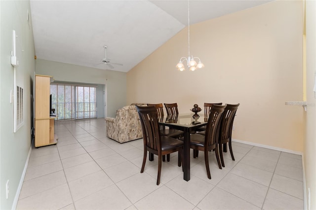 dining room featuring lofted ceiling, ceiling fan with notable chandelier, and light tile patterned floors