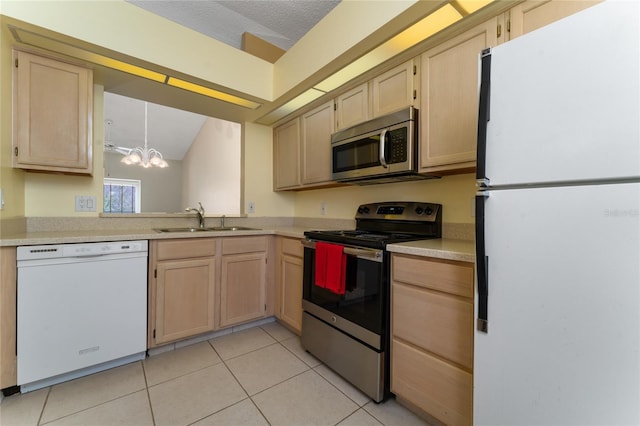 kitchen with sink, appliances with stainless steel finishes, light tile patterned flooring, decorative light fixtures, and light brown cabinets