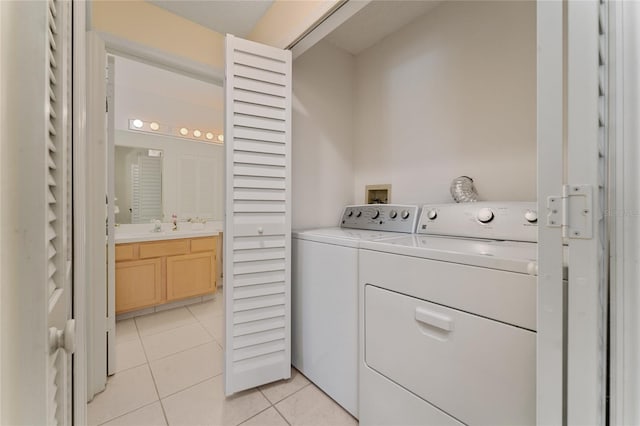 laundry room with light tile patterned flooring and washer and dryer