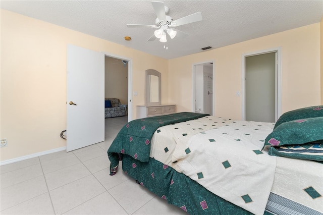 bedroom with tile patterned flooring, ceiling fan, and a textured ceiling