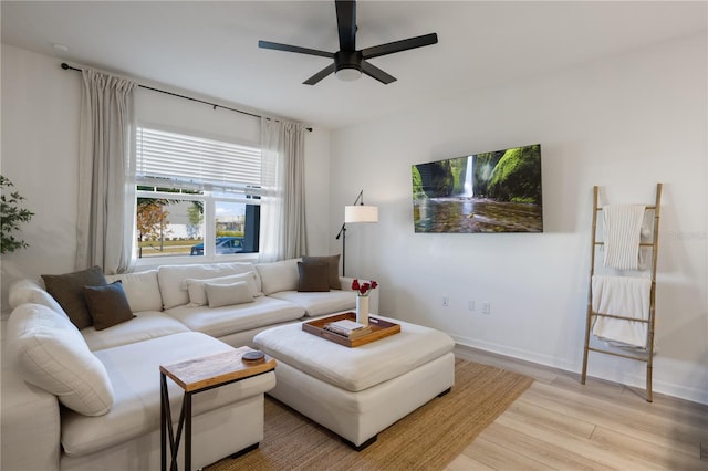 living room with ceiling fan and light hardwood / wood-style flooring