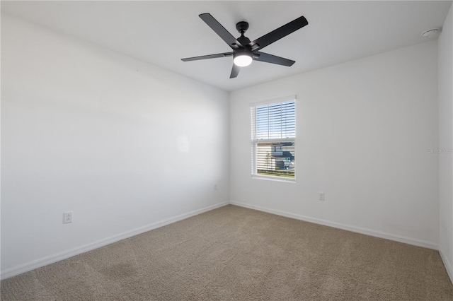 spare room featuring carpet floors and ceiling fan