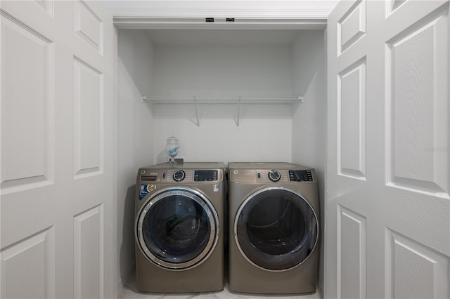 washroom featuring washer and dryer