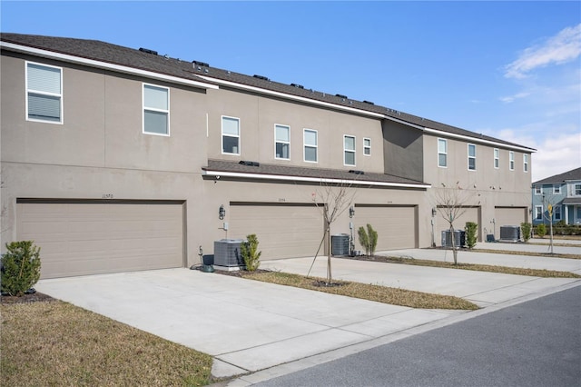 exterior space featuring a garage and cooling unit