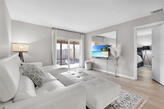 bedroom featuring access to exterior and light wood-type flooring