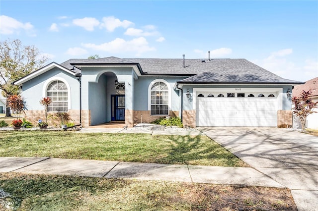 single story home featuring a garage and a front lawn