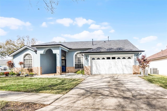 view of front of property with a garage, central AC unit, and a front lawn