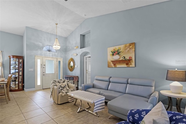 tiled living room with high vaulted ceiling