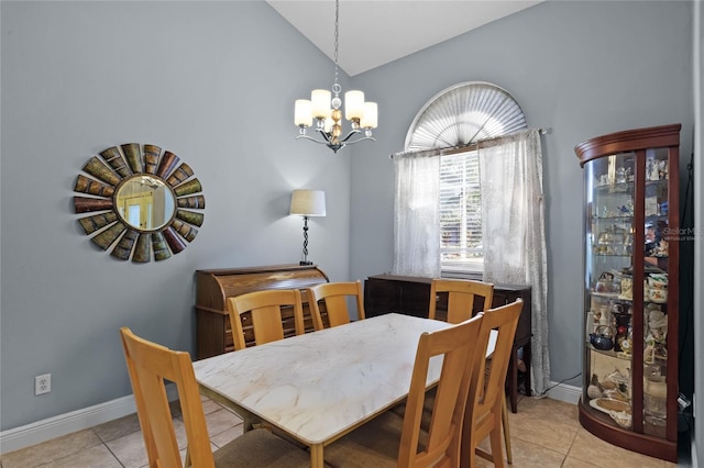 dining area featuring lofted ceiling, an inviting chandelier, and light tile patterned flooring