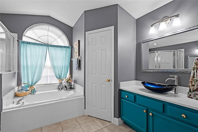 bathroom with tile patterned flooring, vanity, plenty of natural light, and lofted ceiling