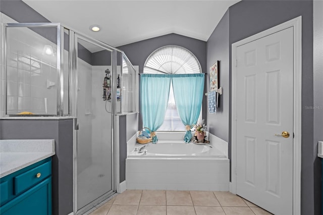 bathroom featuring lofted ceiling, independent shower and bath, tile patterned flooring, and plenty of natural light