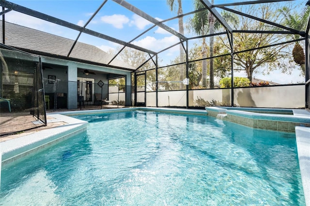 view of swimming pool featuring an in ground hot tub, ceiling fan, a patio area, and glass enclosure