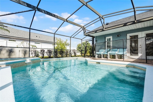 view of swimming pool featuring glass enclosure