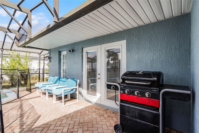 view of patio / terrace featuring a lanai and french doors