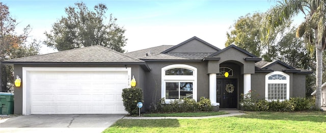 ranch-style house with a garage and a front lawn