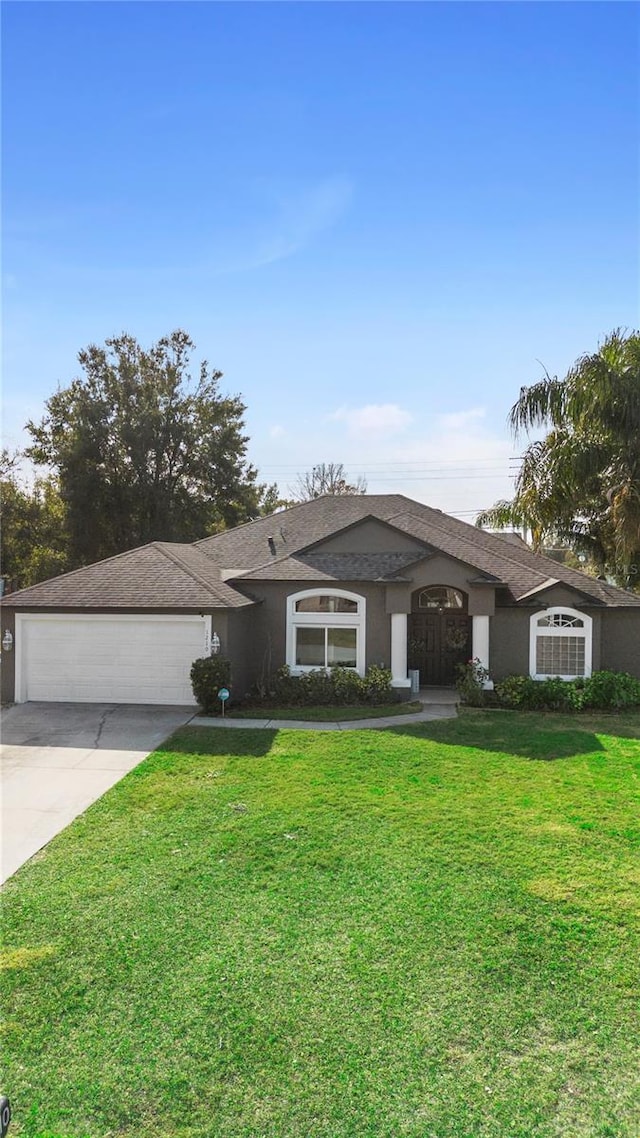 single story home with a garage and a front yard