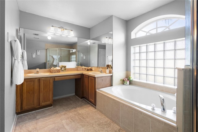 bathroom with vanity and shower with separate bathtub