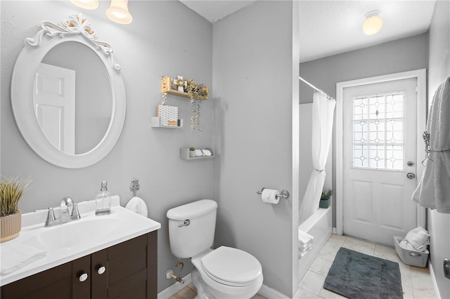 full bathroom with shower / bath combo, vanity, tile patterned floors, and toilet