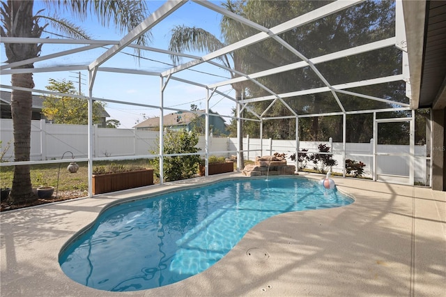 view of swimming pool with a lanai and a patio area