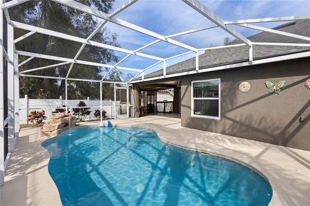 view of swimming pool featuring a lanai, a patio area, and pool water feature