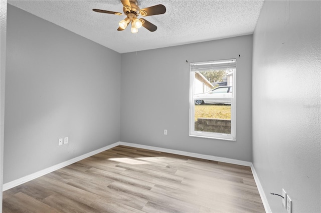 spare room featuring ceiling fan, a textured ceiling, and light wood-type flooring