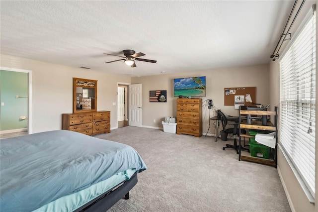 carpeted bedroom with a textured ceiling and ceiling fan