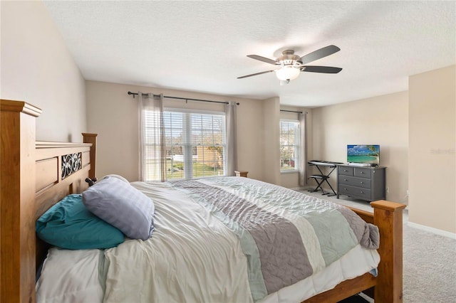 carpeted bedroom with a textured ceiling and ceiling fan