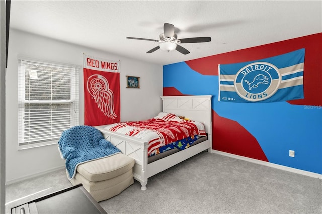 bedroom with ceiling fan, carpet flooring, and a textured ceiling