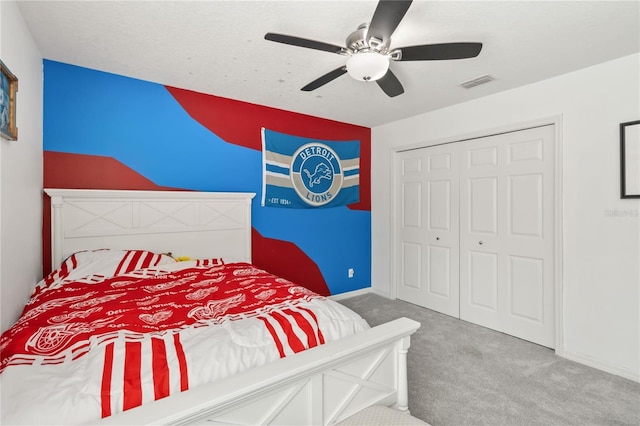 bedroom with a closet, ceiling fan, and carpet flooring