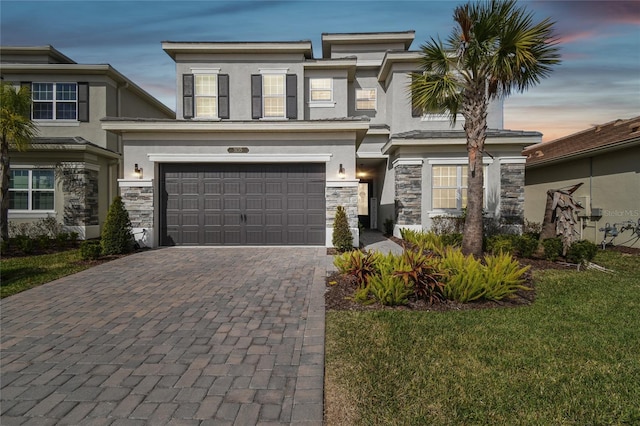 view of front of property with a garage and a yard