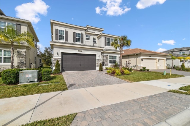 view of front of house with a garage, central AC, and a front yard