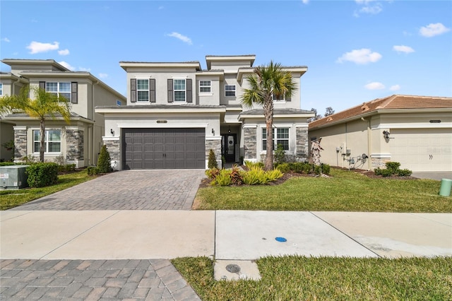 view of front of house with a garage, central AC unit, and a front lawn