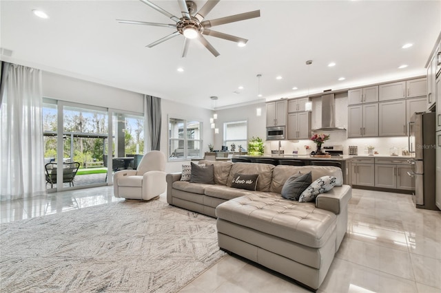 living room featuring a wealth of natural light and ceiling fan