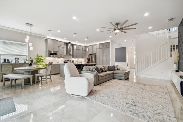 living room featuring sink and ceiling fan