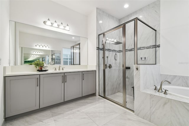 bathroom featuring vanity and independent shower and bath