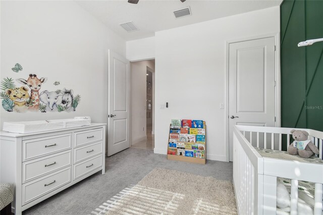 carpeted bedroom with a crib