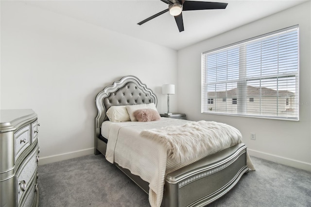 bedroom featuring ceiling fan and dark carpet