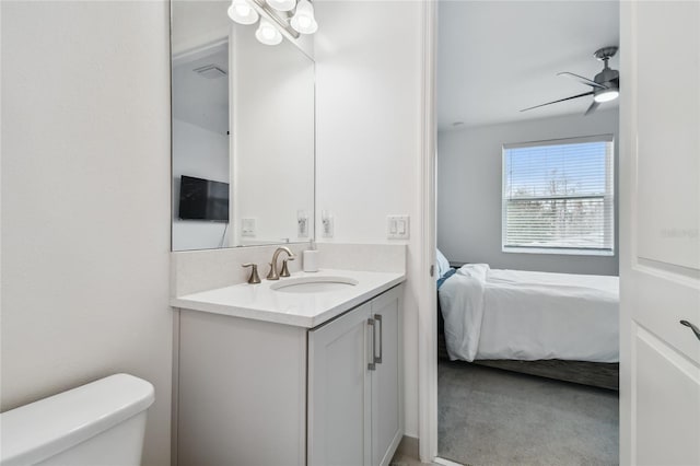 bathroom featuring ceiling fan, vanity, and toilet