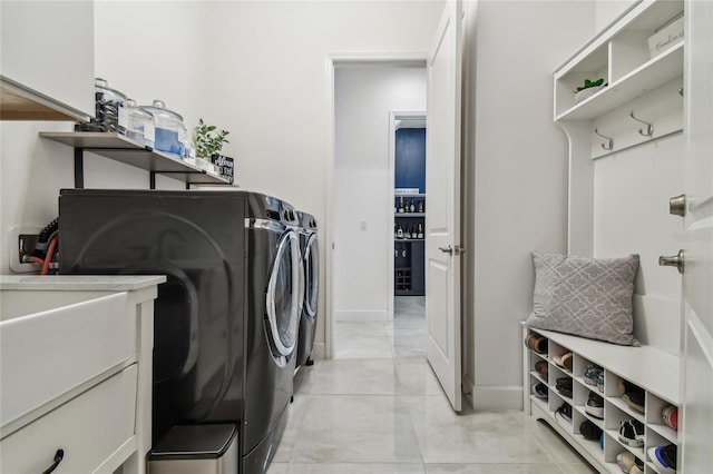 clothes washing area with independent washer and dryer