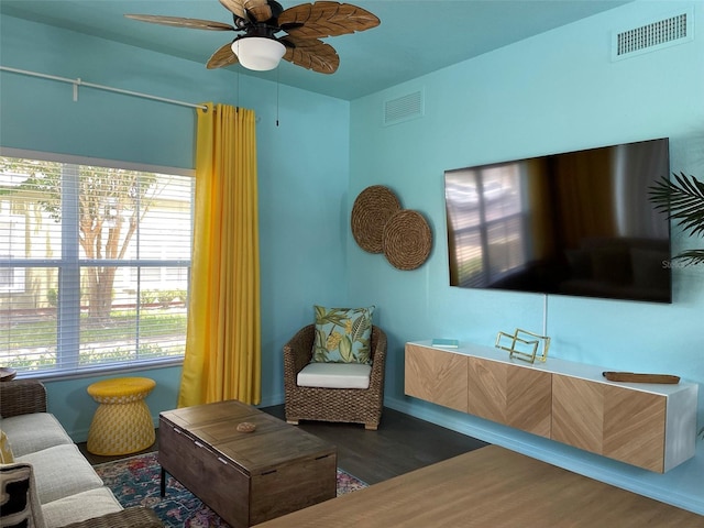 living room with ceiling fan and dark hardwood / wood-style floors