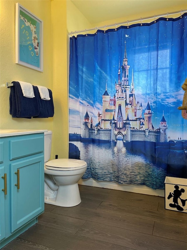 bathroom featuring vanity, hardwood / wood-style floors, toilet, and a shower with shower curtain