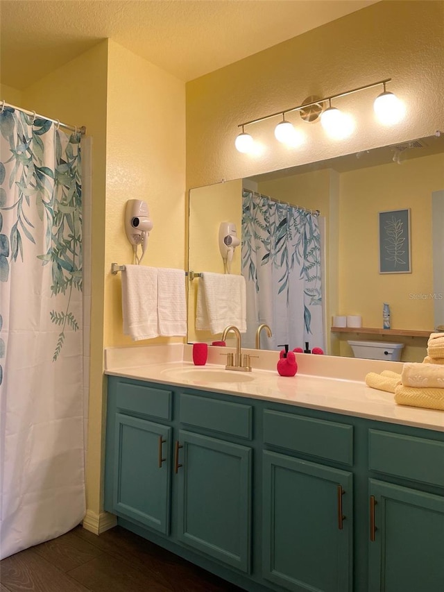 bathroom featuring hardwood / wood-style flooring, vanity, a textured ceiling, and a shower with curtain